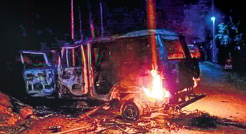 A police vehicle set on fire by villagers over custodial death of a man. (Photo | PTI)