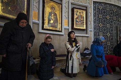 Woman pray inside the Transfiguration of Jesus Orthodox Cathedral, in Kyiv, Ukraine, Sunday, March 20, 2022. (Photo | AP)
