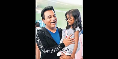 IT Minister K T Rama Rao is all smiles as he is welcomed by a young girl at Los Angeles airport on Sunday.
