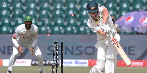 Australia's Cameron Green is bowled out by Pakistan's Naseem Shah on Day 2 of the 3rd Test match at the Gaddafi Stadium in Lahore. (Photo| AP)