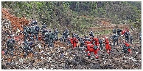 Rescue workers search for the black boxes at a plane crash site in Tengxian county, southwestern China's Guangxi Zhuang Autonomous Region, Tuesday, March 22, 2022.  (Photo |AP)