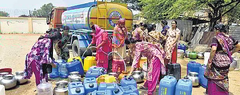 Residents of camps at Osmania University collect water from a tanker on Tuesday | Vinay Madapu