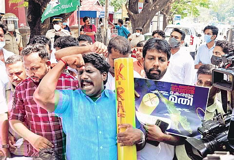 Congress workers, holding replica of survey stone, taking out a march against SilverLine project near Kanayannur Taluk Office in Kochi on Tuesday | A Sanesh