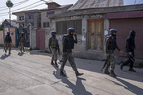 Indian paramilitary soldiers patrol near the area where suspected rebels opened fire on a policeman on the outskirts of Srinagar. (Photo | AP)