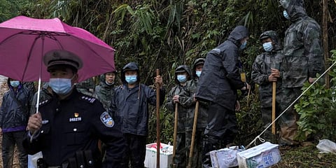 Soldiers hold shovels as they preparing to head to the crashed site of the China Eastern Flight 5735 to search for the black box, Thursday, March 24, 2022.(Photo | AP)