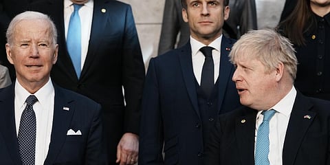 British PM Boris Johnson, front right, looks toward U.S. President Joe Biden, front left, at a group photo during an extraordinary NATO summit Thursday, March 24, 2022.(Photo | AP)
