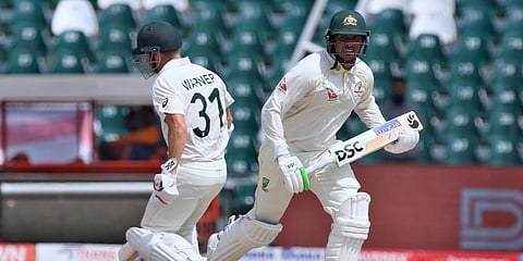 Australia's Usman Khawaja (R) and David Warner run between the wickets on Day 4 of the 3rd Test match against Pakistan at the Gaddafi Stadium in Lahore. (Photo| AP)