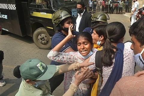 Police detain Socialist Unity Centre of India (SUCI) activists during their protest against the alleged mass killing at Rampurhat of Birbhum district, outside Bengal Assembly. (Photo | PTI)