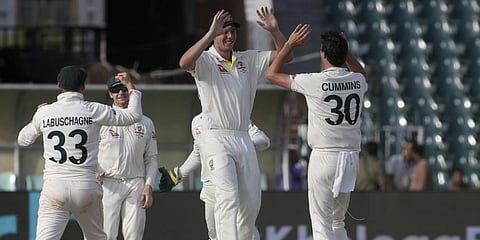 Australia's Cameron Green, center, and teammates celebrate after winning the third test match against Pakistan.(Photo | AP)