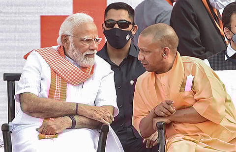 Prime Minister Narendra Modi with BJP leader Yogi Aditiyanath, during the latters swearing-in ceremony as Uttar Pradesh Chief Minister, at Atal Bihari Ekana Stadium in Lucknow, Friday. (Photo | PTI)