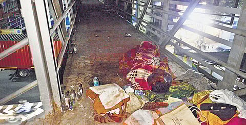 A man sleeping on a foot overbridge near New College at Royapettah in Chennai on Tuesday night | DEBADATTA MALLICK
