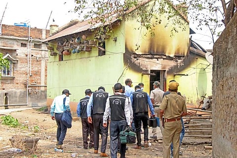 CBI's Central Forensic Science Laboratory's (CFSL) experts collect samples from the houses where eight people were burned alive. (Photo | PTI)