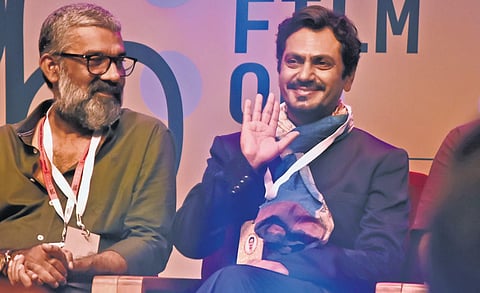 Actor Nawazuddin Siddiqui, the chief guest at the concluding ceremony of the International Film Festival of Kerala, waving at the audience at Nisagandhi auditorium in Thiruvananthapuram. Chalachithra