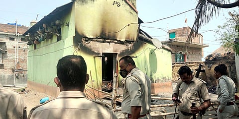 Police personnel inspecting a burned house after a mob allegedly set it on fire in West Bengal's Birbhum. (Photo| ANI)