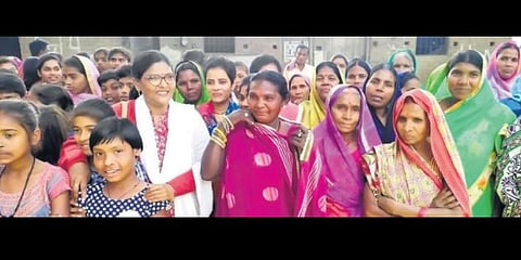 Reeta Kaushik with the village women among whom she works; (right) educating the villagers | EXPRESS