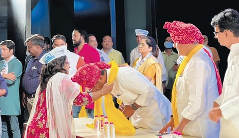 Workers being greeted during the AAP conference in Jaipur on Sunday | express