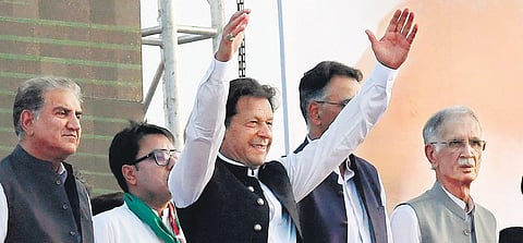 Pakistan Prime Minister Imran Khan (C) along with other lawmakers, gestures upon his arrival to address a rally of his party, in Islamabad. (Photo | AFP)