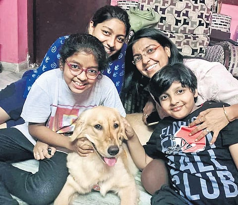 Ruby, the seven-month-old golden retriever, along with her family. ( Photo | EPS)