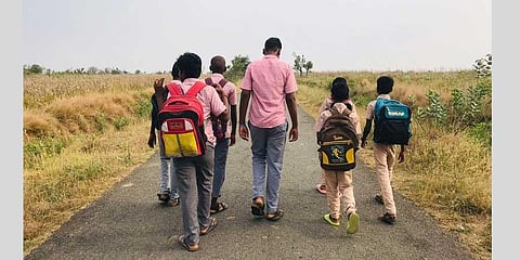 Students walking to the government higher secondary school from Kurumbapalayam in Perambalur district | Express