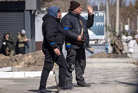 Volunteers stand guard at a checkpoint in Stoyanka, on March 27, 2022. (Photo | AFP)