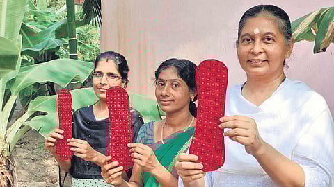 Anju Bist and her team with the world’s first reusable menstrual pads they made  from banana fibre, which comes from agro-waste