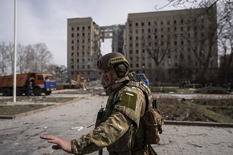A Ukrainian soldier secures the area next to the regional government headquarters of Mykolaiv, Ukraine, following a Russian attack. (Photo | AP)