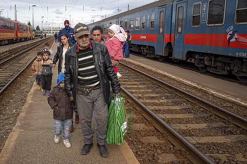 Refugees fleeing the war from neighboring Ukraine walk on a platform after disembarking from a train in Zahony, Hungary. (Photo | AP)