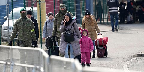 People fleeing from Ukraine wheel their luggage on the border in Vysne Nemecke, Slovakia. (Photo| AP)