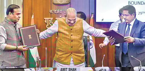 Assam CM Himanta Biswa Sarma(L) and his Meghalaya counterpart Conrad K Sangma (R) share the agreement to resolve the boundary dispute between their states, in the presence of Union Home Minister Amit