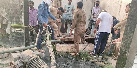 Firefighters and plant workers during a rescue operation after two workers fell into a pit of a sewage plant of the Delhi Jal Board, at Dallupura in New Delhi. (Photo| PTI)