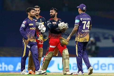 Dinesh Karthik and Harshal Patel of Royal Challengers Bangalore with Kolkata Knight Riders players, after winning match 6 of the Indian Premier League 2022. (Photo | PTI)