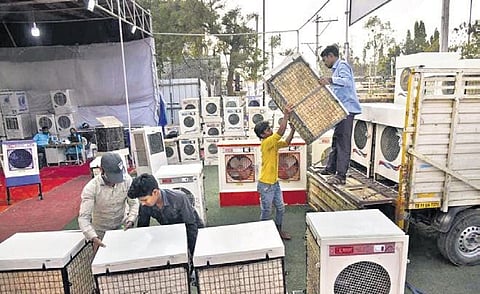Workers unload air coolers at a shop in Hyderabad on Wednesday. Due to heatwave conditions, the demand for air coolers has increased in the city. ( Photo | EPS)