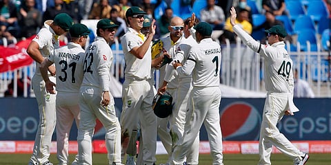 Australian team celebrates after taking the wicket of Pakistan's Abdullah Shafique during Fay 1 of 1st Test match in Rawalpindi. (Photo| AP)