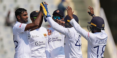 Sri Lankan team celebrates the wicket of India's Virat Kohli during the 1st Test match in Mohali. (Photo| AP)