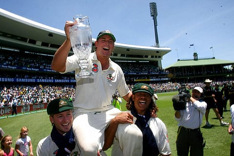 Australia's Shane Warne is carried around the field with the official Ashes Trophy by Michael Clarke and Andrew Symonds. (Photo | AP)