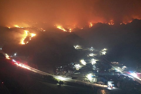 A wildfire burns on a mountain in Samcheok, South Korea, Friday, March 4, 2022. (Photo | AP)