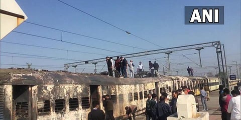 Fire broke out in the engine and two compartments of a train going from Saharanpur to Delhi, earlier today at Daurala railway station near Meerut. (Photo | ANI)