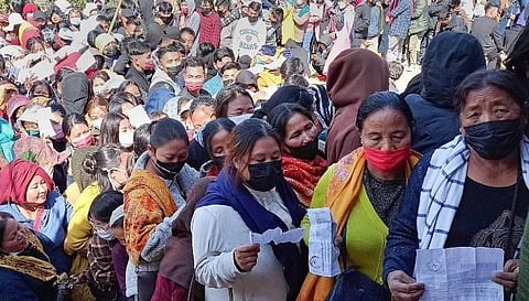 Voters holding their identification cards stand in queues to cast their votes for the second phase of Manipur Assembly elections, in Senapati. (Photo | PTI)