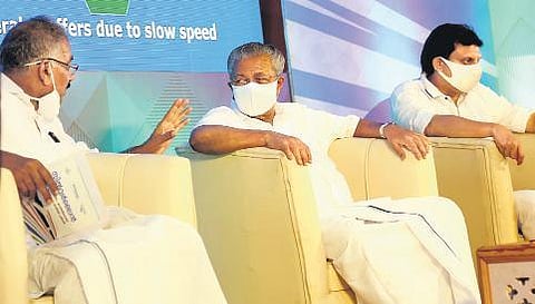 Chief Minister Pinarayi Vijayan, centre, and Forest Minister A K Saseendran, left, interact during the SilverLine explanatory meeting in Kozhikode on Saturday, March 5, 2022. (Photo | EPS)