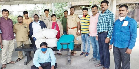 The Government Railway Police team with the 21 kg of ganja seized on Saturday from a passenger who came to Bengaluru by Kakinada Express.