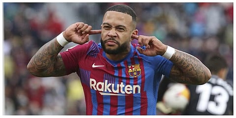 Barcelona's Memphis Depay celebrates after scoring his side's second goal from a penalty kick during a Spanish La Liga soccer match between Elche and Barcelona at the Martinez Valero stadium in Elche.