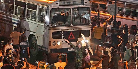A Sri Lankan policeman tries to disperse protesters outside Sri Lanka President Gotabaya Rajapaksa's private residence on the outskirts of Colombo, Sri Lanka. (Photo | AP)