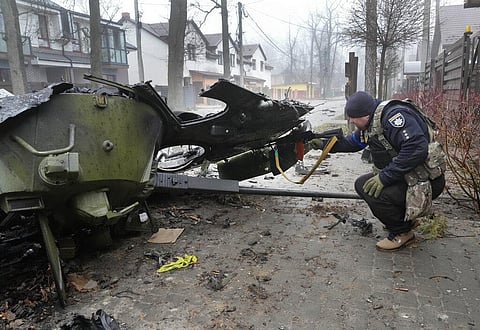 A Ukrainian soldier checks a destroyed Russian tank, in Irpin close to Kyiv, Ukraine, Friday, Apr. 1, 2022. (Photo | AP)
