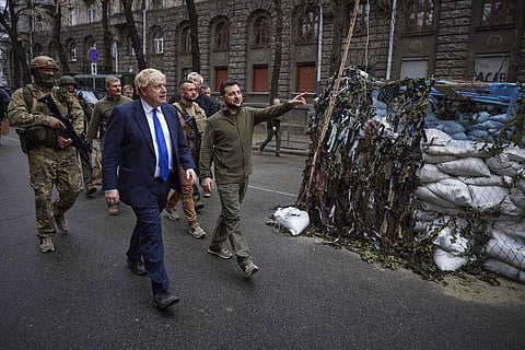 Ukrainian President Volodymyr Zelenskyy, center, and Britain's Prime Minister Boris Johnson, center left, walk in downtown Kyiv. (Photo | AP)