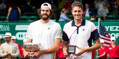 Reilly Opelka (L) and John Isner are pictured on the court after Opelka defeated Isner in the men's singles final of the U.S. Clay Court Tennis Championships at River Oaks Country Club. (Photo | AP)