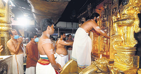 Melsanthi Parameswaran Nampoothiri opening the sreekovil of Sabarimala  temple in the presence of thantri Mahesh Mohanaru on Sunday