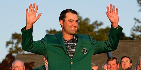 Scottie Scheffler celebrates after putting on the green jacket after winning the 86th Masters golf tournament in Augusta. (Photo | AP)