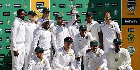 South Africa's Dean Elgar (C) holds the trophy as his team poses for a photo after winning the series following the second Test cricket match against Bangladesh at St George's Park. (Photo | AFP)