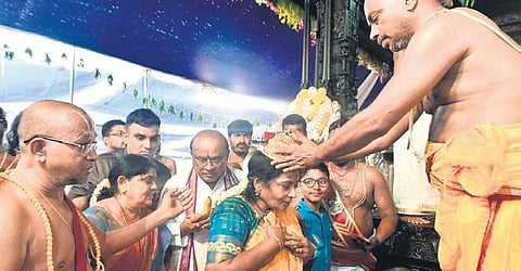 Governor Tamilsai Soundararajan seeks blessings from the priests after attending the Pattabhishekam at the Mithila Stadium in Bhadrachalam on Monday