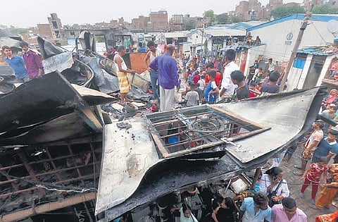 People search for leftover belongings after a fire in Anand Parbat area. (Photo | Parveen negi, EPS)